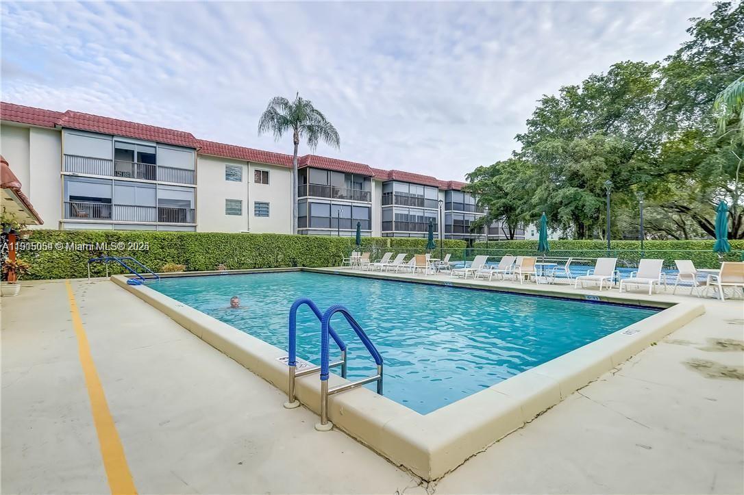 9520 South Hollybrook Lake Drive, Unit 205 Pembroke Pines, FL 33025 - Photo 18 of 22 a view of swimming pool with a patio