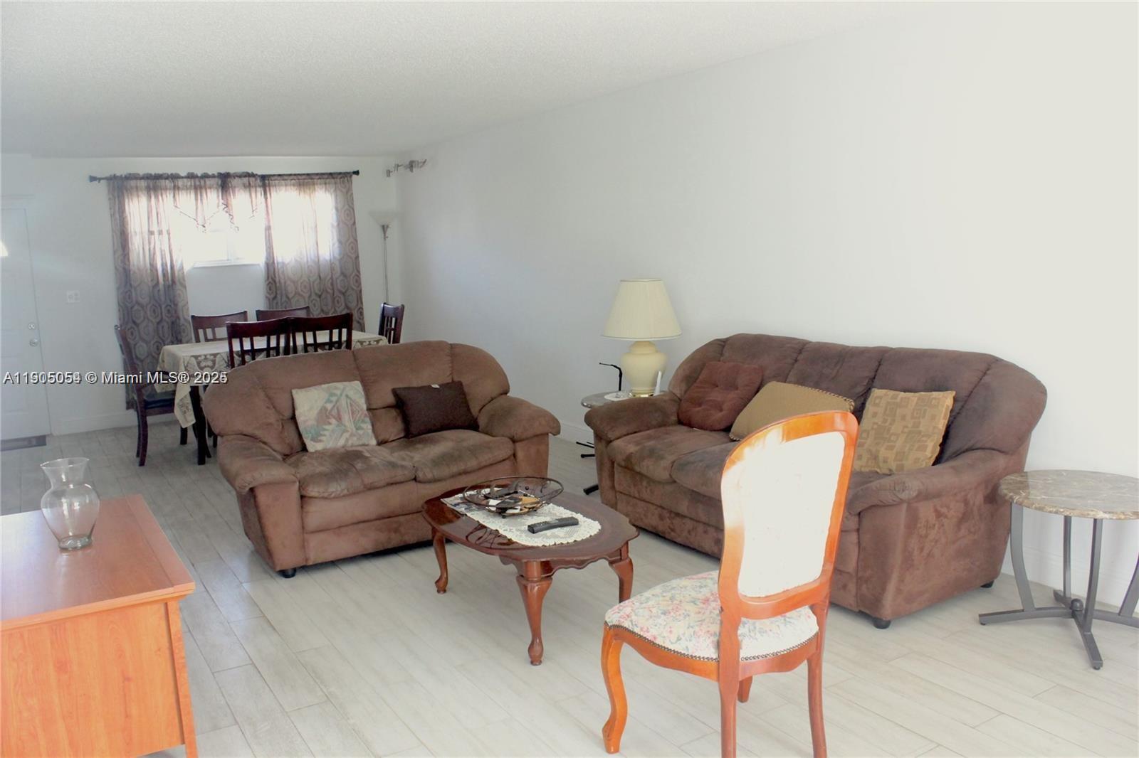 9520 South Hollybrook Lake Drive, Unit 205 Pembroke Pines, FL 33025 - Photo 5 of 22 a living room with furniture and a potted plant