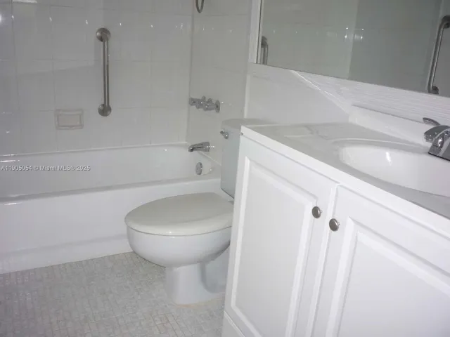 a bathroom with a sink a toilet and bathtub