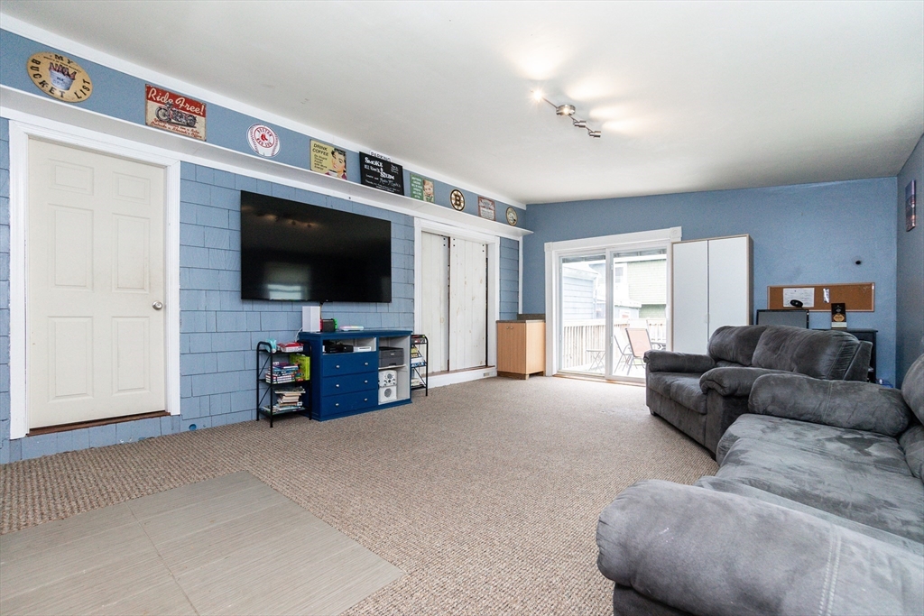 67 West Shore Road Holbrook, MA 02343 - Photo 18 of 42 a living room with furniture and a flat screen tv