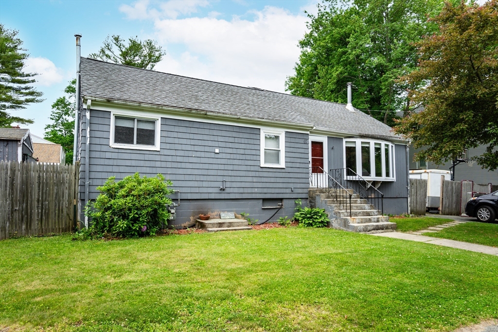 67 West Shore Road Holbrook, MA 02343 - Photo 41 of 42 a front view of a house with a yard and green space