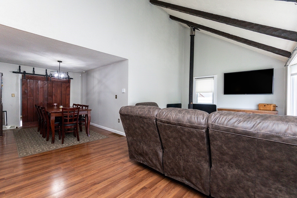 67 West Shore Road Holbrook, MA 02343 - Photo 8 of 42 a living room with furniture and a flat screen tv