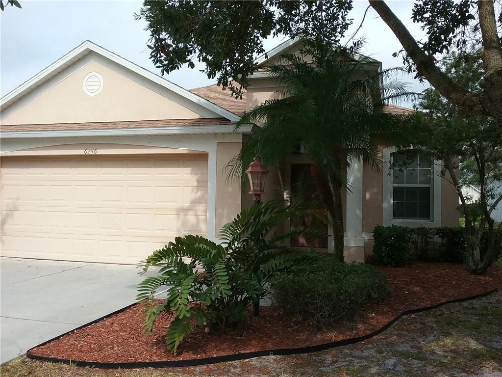 6246 Blue Runner Court Lakewood Ranch, FL 34202 - Photo 2 of 13 a front view of a house with garden
