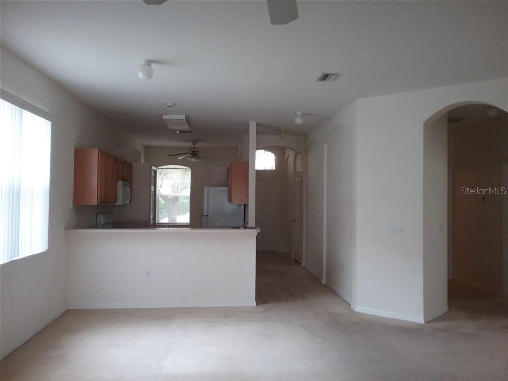 6246 Blue Runner Court Lakewood Ranch, FL 34202 - Photo 6 of 13 an empty room with windows and fireplace