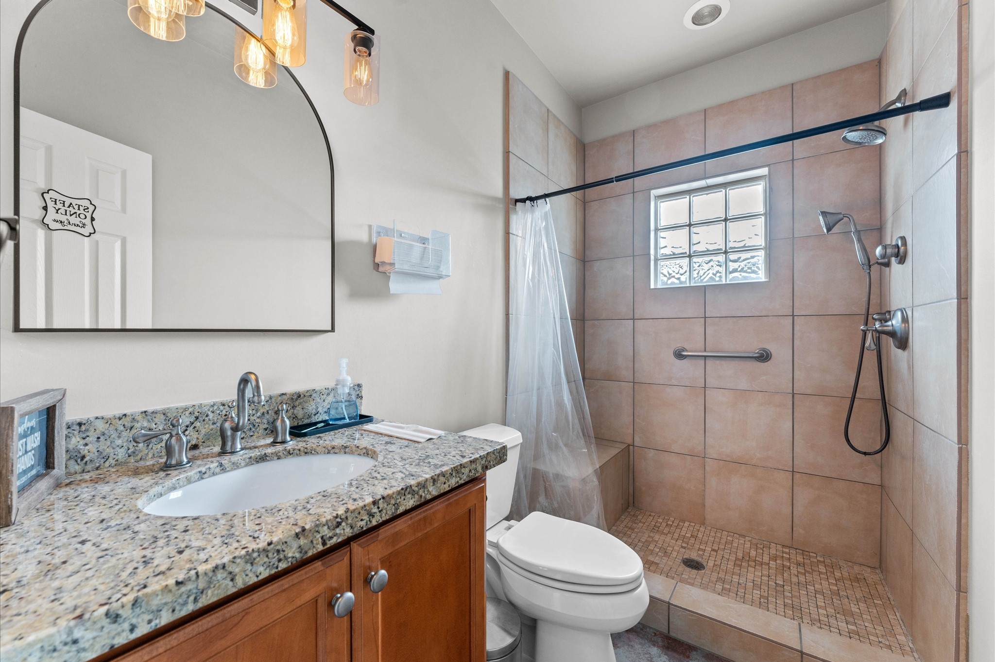 945 Harvard Street Houston, TX 77008 - Photo 34 of 47 a bathroom with a granite countertop sink toilet and shower