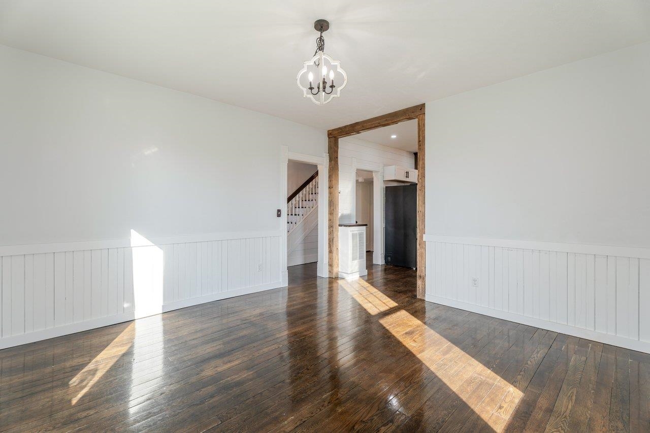 164 Church Street Timberville, VA 22853 - Photo 11 of 68 a hallway with wooden floor chandelier and a window
