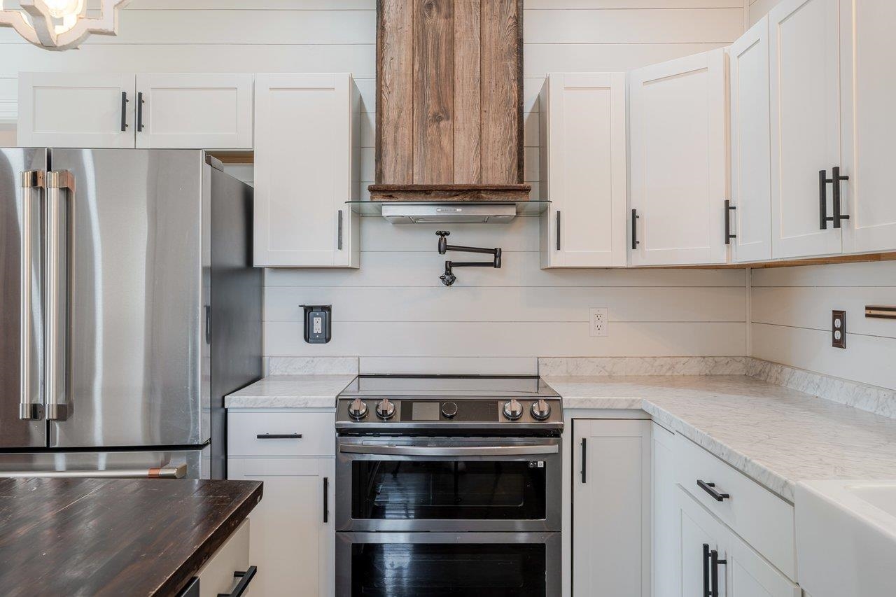 164 Church Street Timberville, VA 22853 - Photo 16 of 68 a kitchen with stainless steel appliances granite countertop a stove a refrigerator and a white cabinets