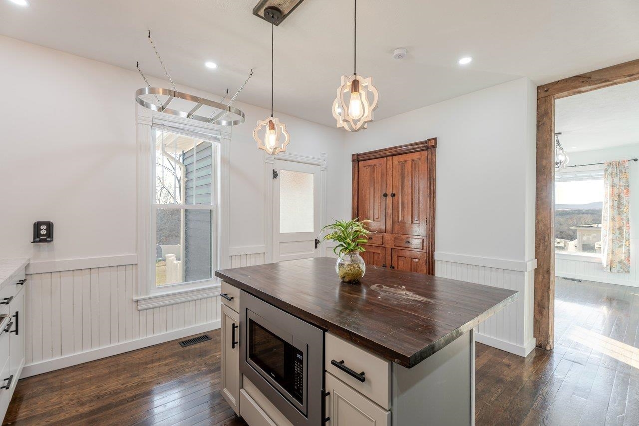 164 Church Street Timberville, VA 22853 - Photo 17 of 68 a kitchen with stainless steel appliances granite countertop stove a sink and wooden floor
