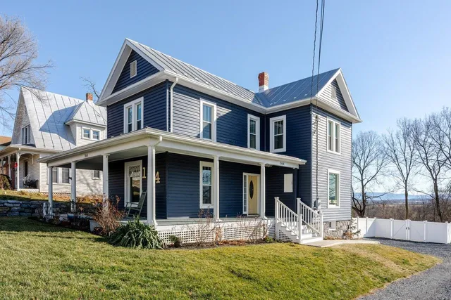 a view of a house with yard porch and furniture