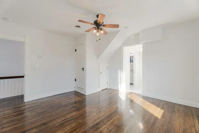 a view of an empty room and wooden floor