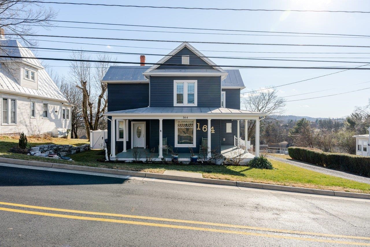 164 Church Street Timberville, VA 22853 - Photo 53 of 68 a view of a white house with a large windows and a table and chairs