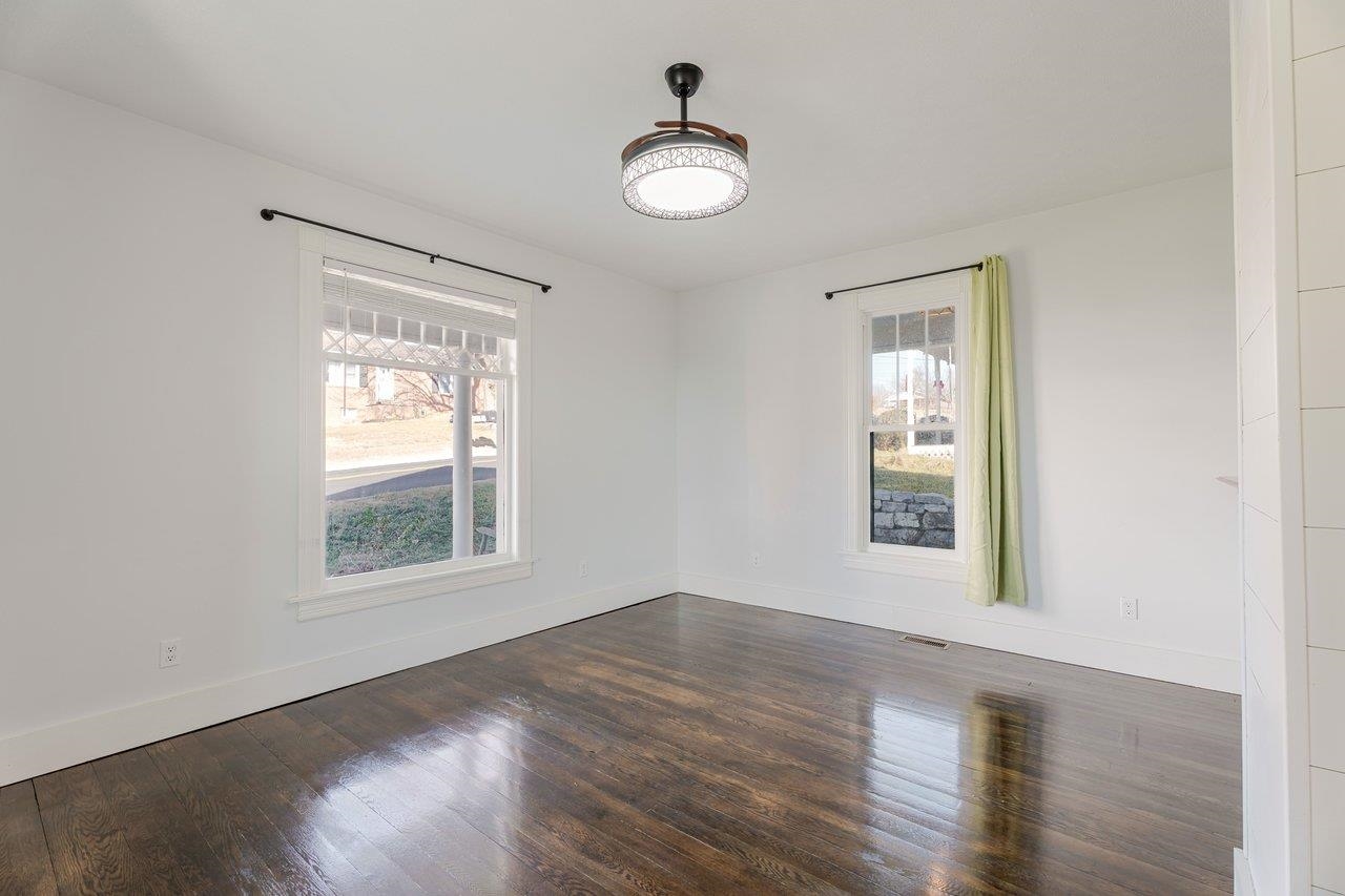 164 Church Street Timberville, VA 22853 - Photo 6 of 68 an empty room with wooden floor and windows