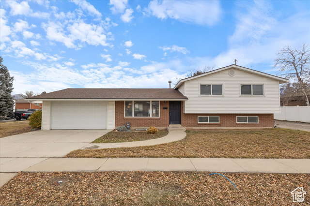 7437 Ramanee Drive Midvale, UT 84047 - Photo 1 of 1 Tri-level home featuring a garage