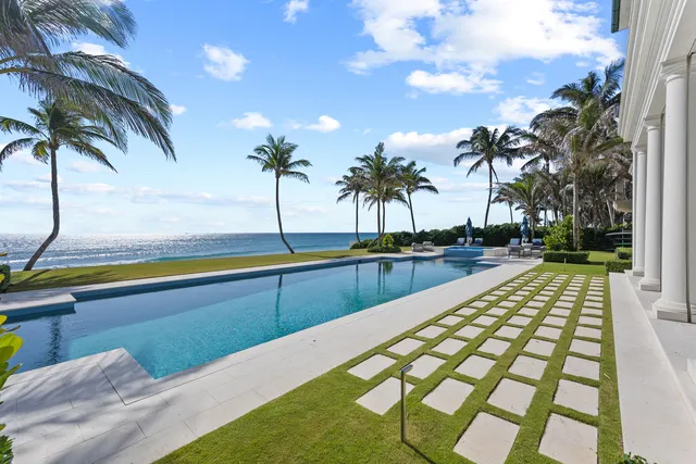 a view of a swimming pool with a table and chairs