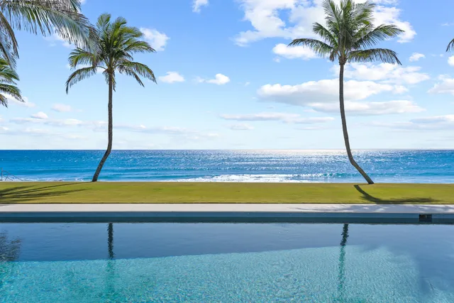 a view of a building with a swimming pool and a bench