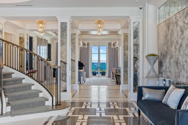 a living room with furniture and a chandelier
