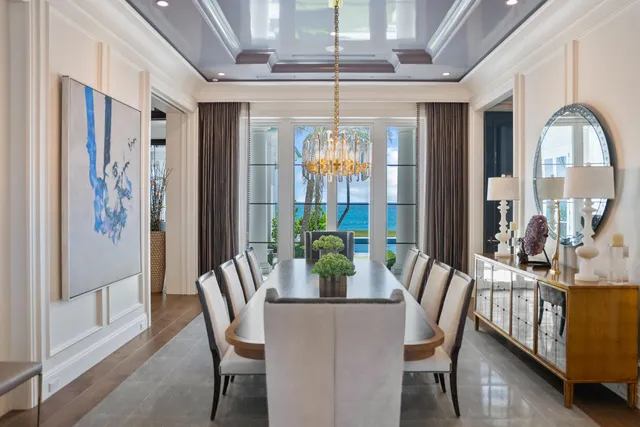 a dining room with furniture a chandelier and fireplace