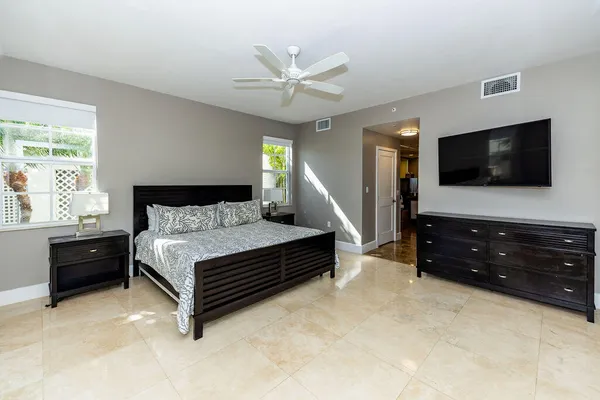 a bedroom with furniture and a flat screen tv