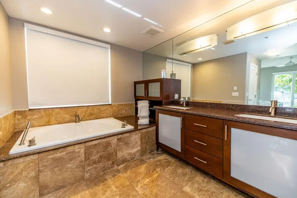 a large bathroom with a large tub and sink