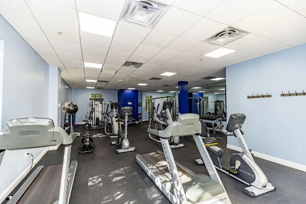 a room with lots of furniture and view of kitchen