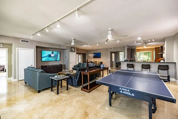 a room with furniture pool table and windows