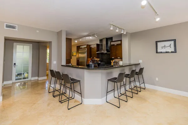 a kitchen with stainless steel appliances granite countertop a refrigerator and a sink