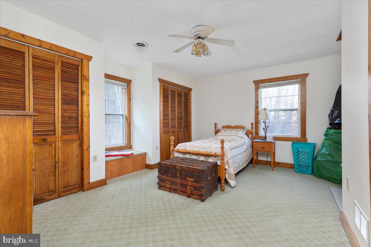 209 Park Ridge Court Front Royal, VA 22630 - Photo 27 of 60 a spacious bedroom with a bed and a chandelier