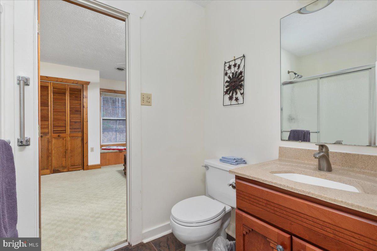 209 Park Ridge Court Front Royal, VA 22630 - Photo 28 of 60 a bathroom with a granite countertop toilet sink and mirror