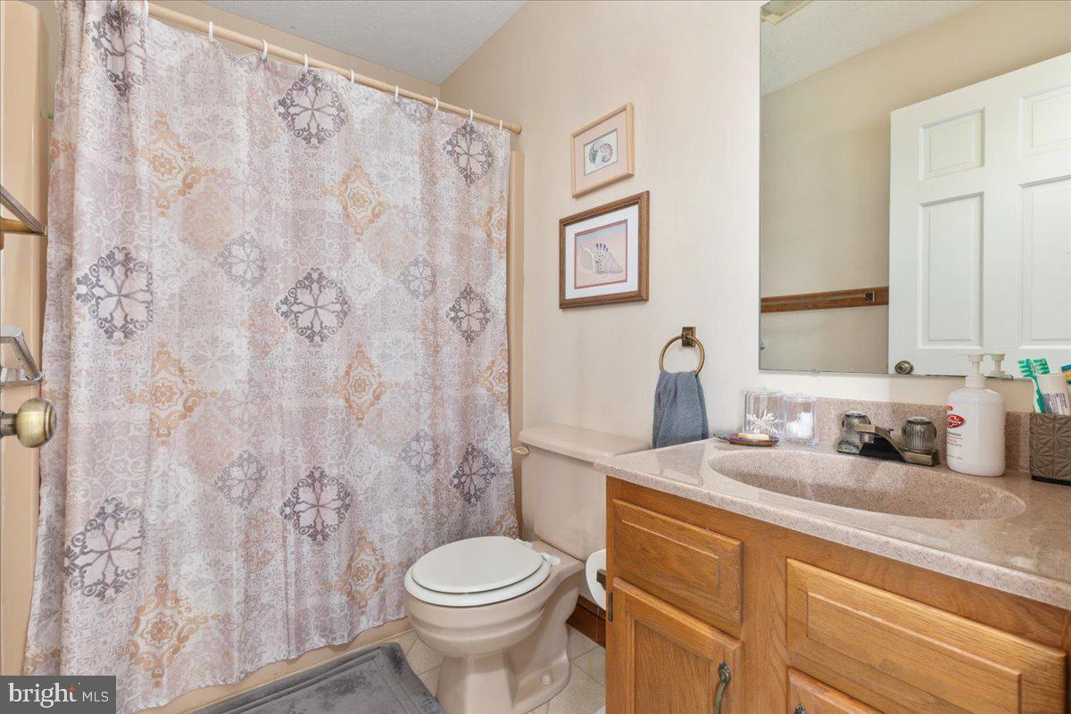 209 Park Ridge Court Front Royal, VA 22630 - Photo 31 of 60 a bathroom with a granite countertop toilet sink and mirror