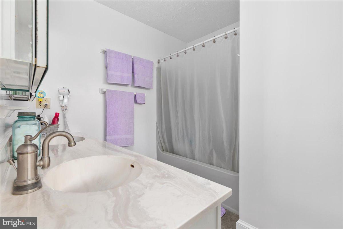 209 Park Ridge Court Front Royal, VA 22630 - Photo 37 of 60 a bathroom with a sink and a mirror