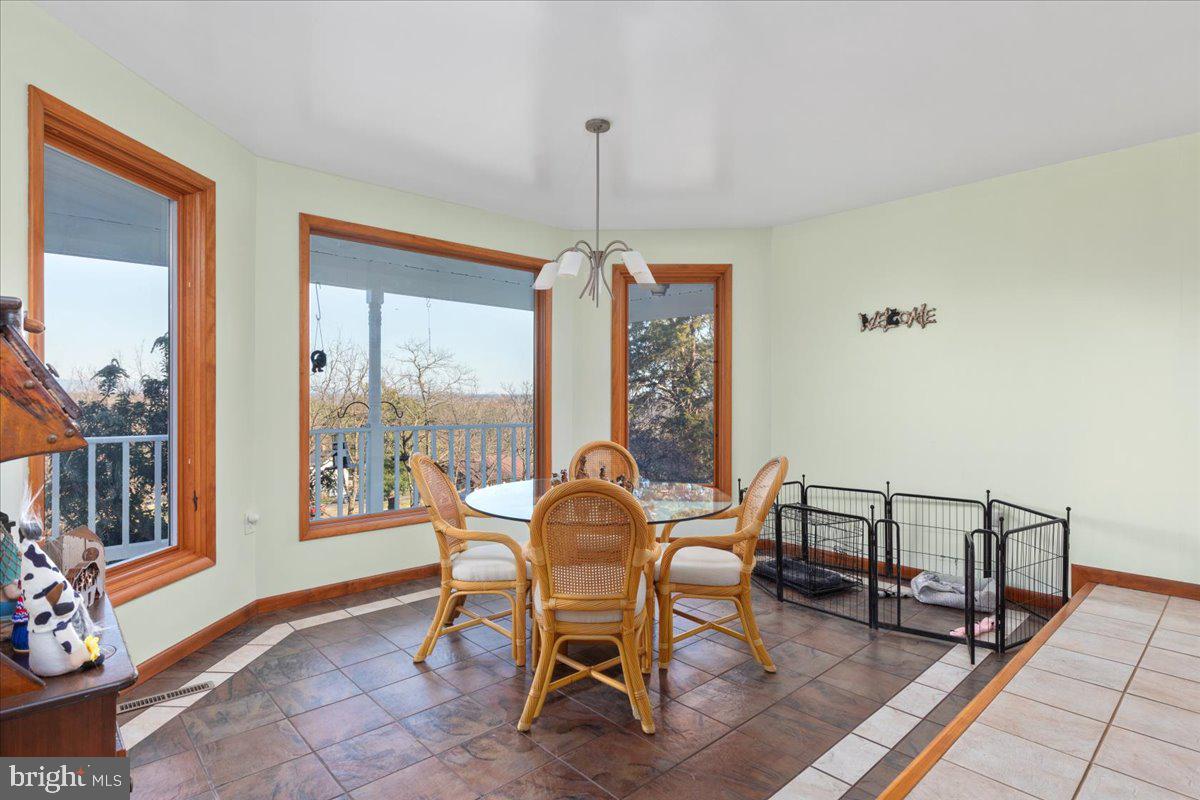 209 Park Ridge Court Front Royal, VA 22630 - Photo 10 of 60 a dining room with furniture a chandelier and wooden floor