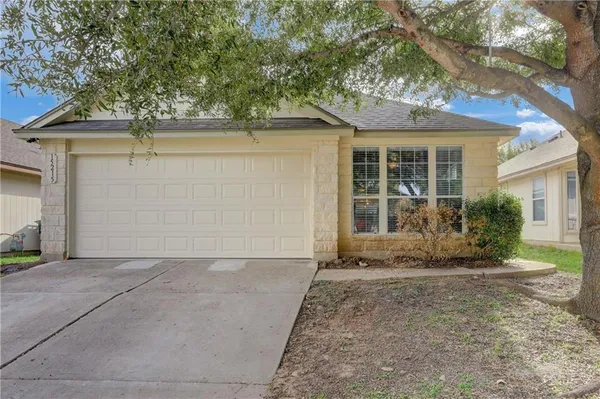 front view of a house with a tree
