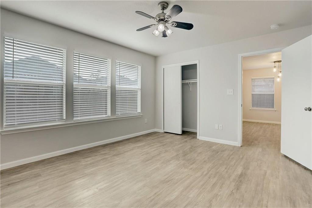 15215 Parrish Lane Austin, TX 78725 - Photo 5 of 10 a view of an empty room with a window and wooden floor