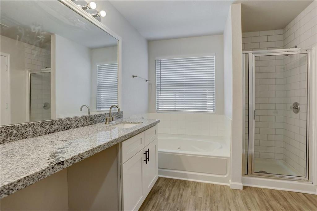 15215 Parrish Lane Austin, TX 78725 - Photo 6 of 10 a bathroom with a granite countertop sink a toilet and shower