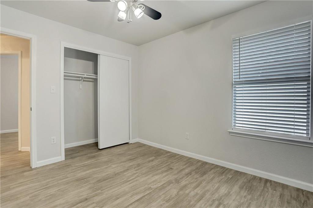15215 Parrish Lane Austin, TX 78725 - Photo 8 of 10 an empty room with wooden floor and windows