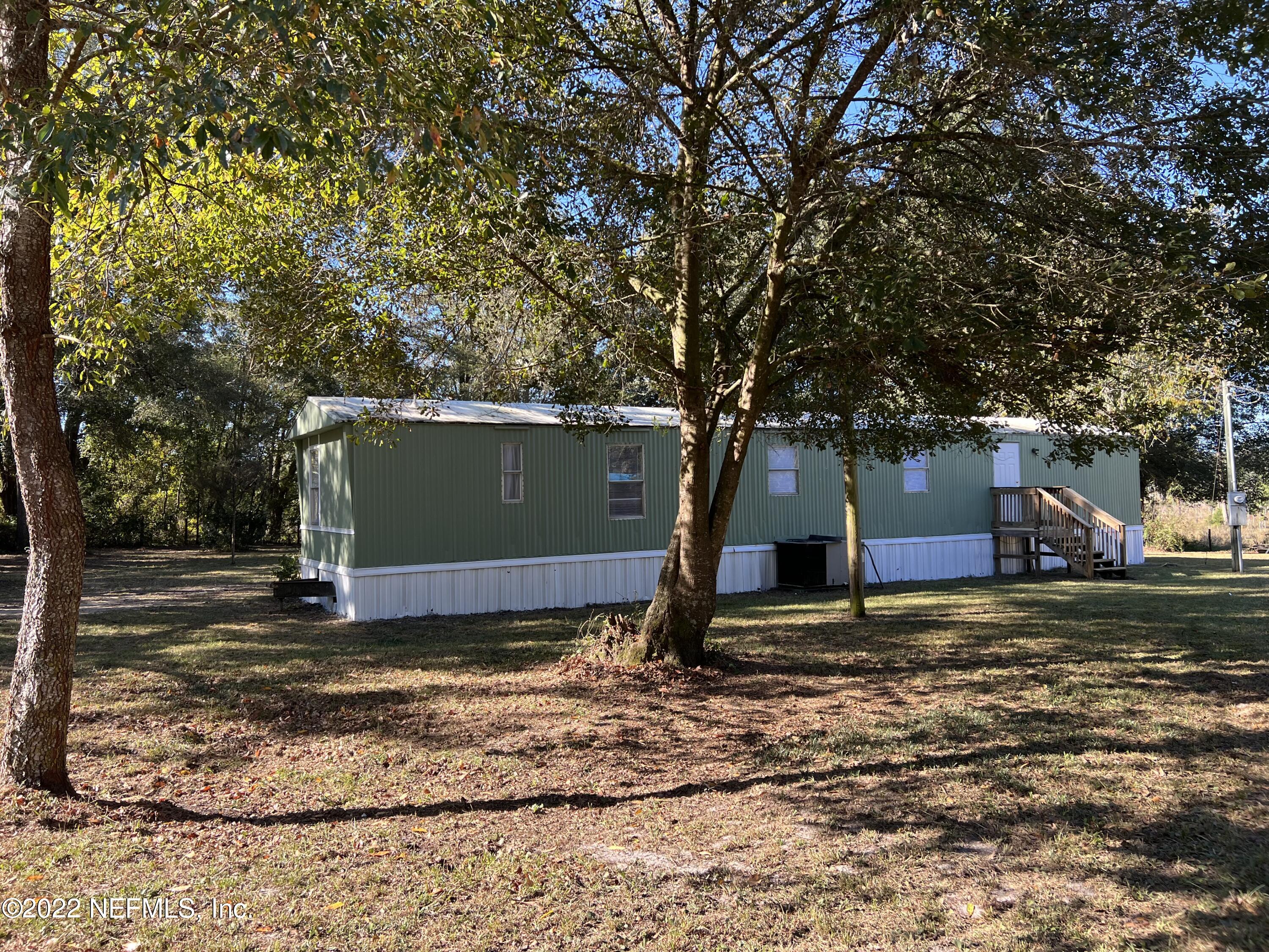 8008 Sunnybrook Road Melrose, FL 32666 - Photo 15 of 17 a view of a backyard with large tree