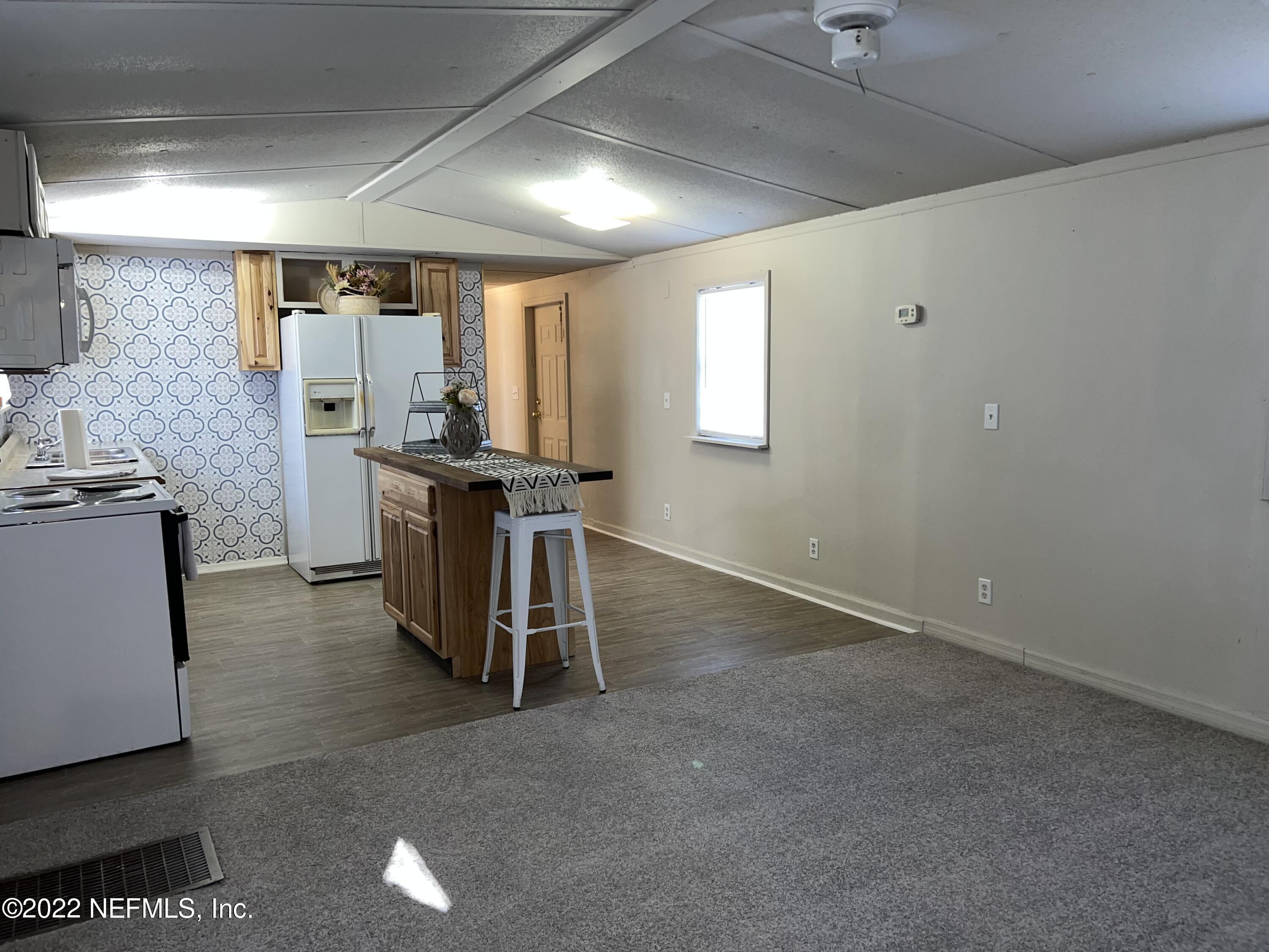 8008 Sunnybrook Road Melrose, FL 32666 - Photo 6 of 17 a view of a kitchen with furniture and a kitchen