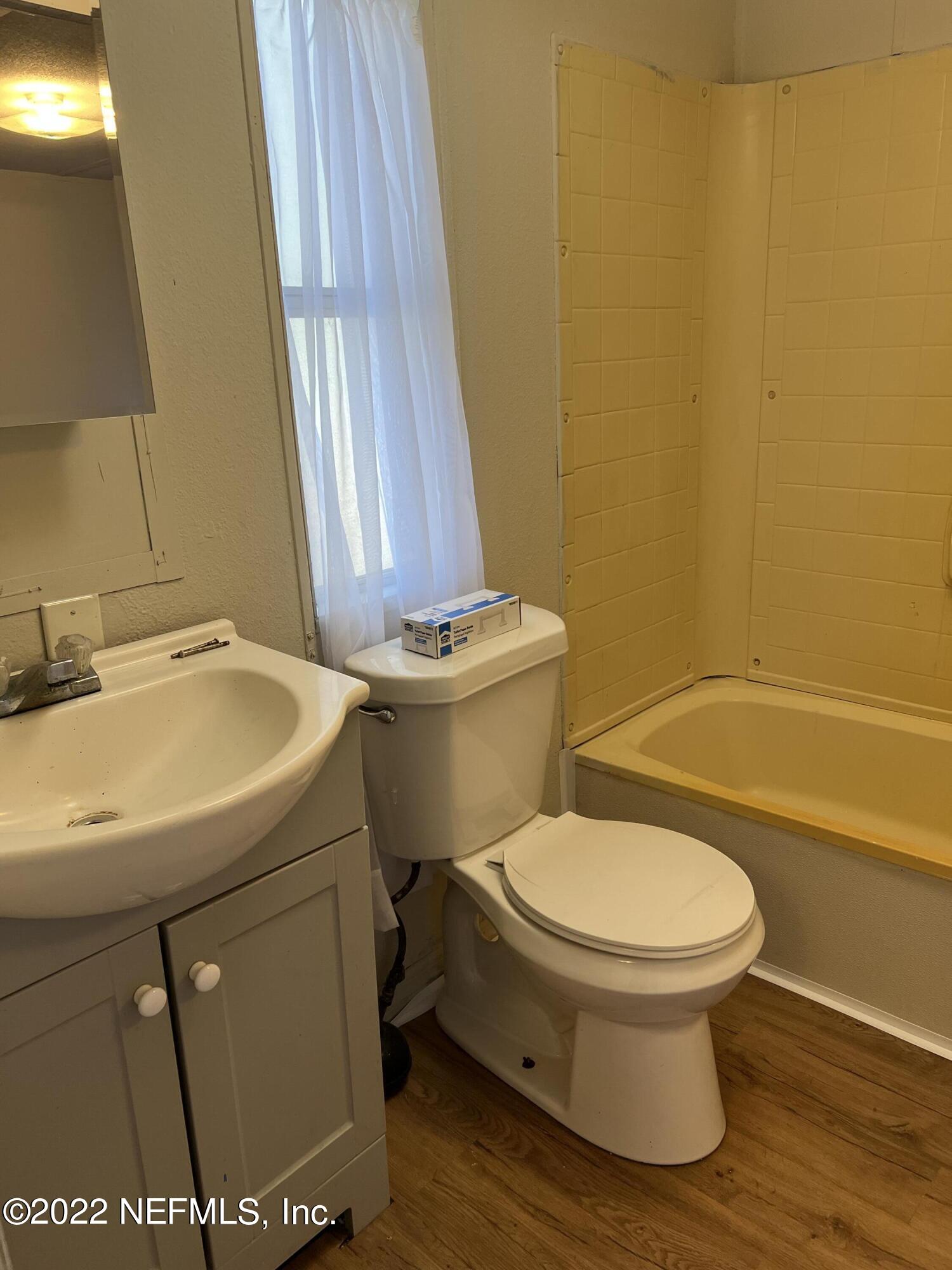 8008 Sunnybrook Road Melrose, FL 32666 - Photo 8 of 17 a white toilet sitting next to a bathroom sink