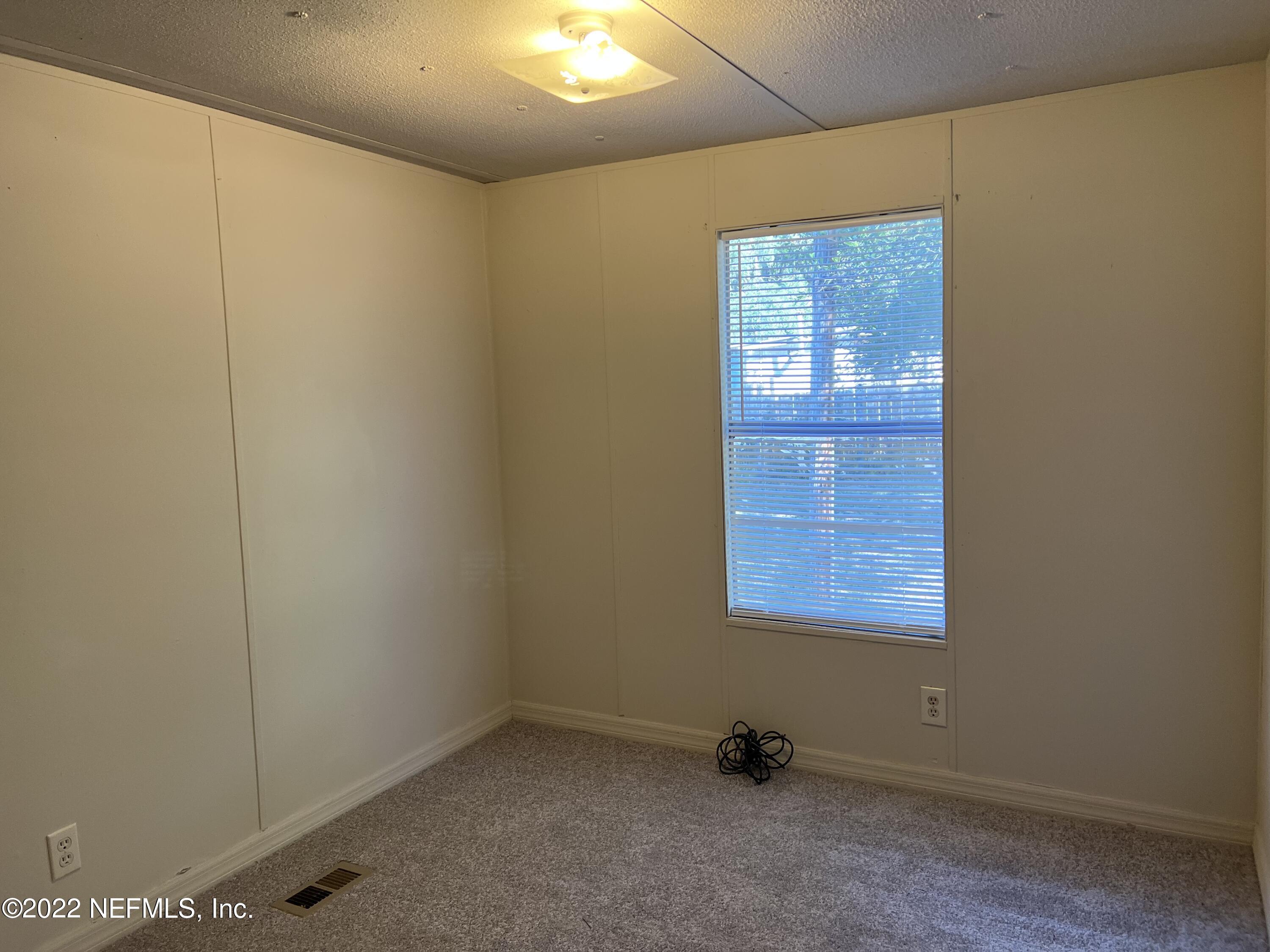 8008 Sunnybrook Road Melrose, FL 32666 - Photo 9 of 17 a view of an empty room with a window