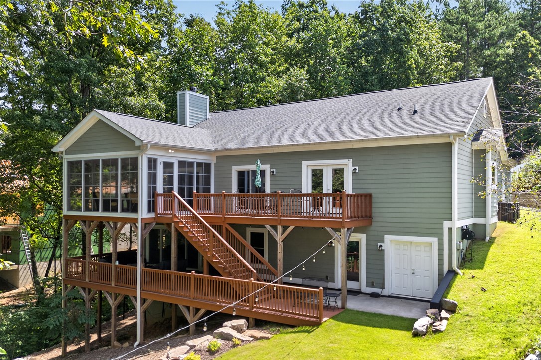 321 High Hampton Road Salem, SC 29676 - Photo 2 of 46 Multi-level wooden decks and a screened porch expand the rear living space into the trees.