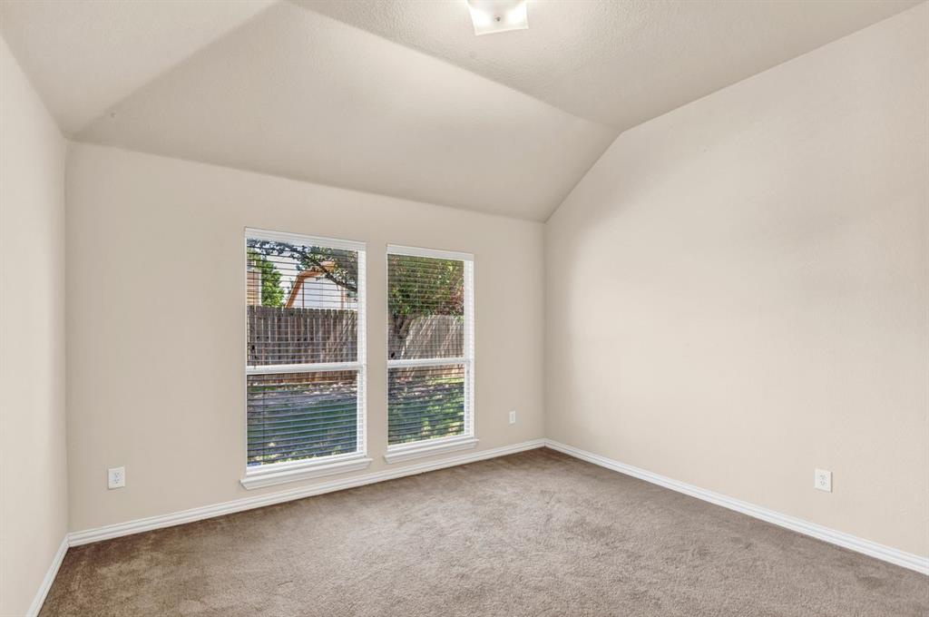 5316 Ridgeson Drive McKinney, TX 75071 - Photo 19 of 33 Spacious room featuring vaulted ceilings, light neutral wall tones, and carpet flooring