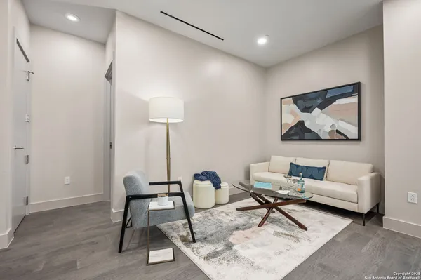 a living room with furniture and a lamp
