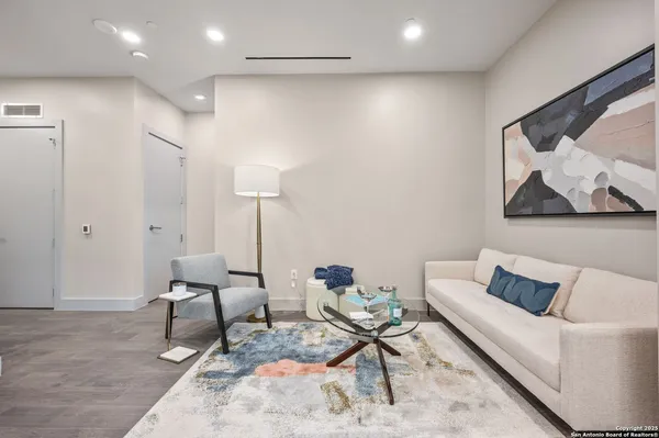 a living room with furniture and a rug