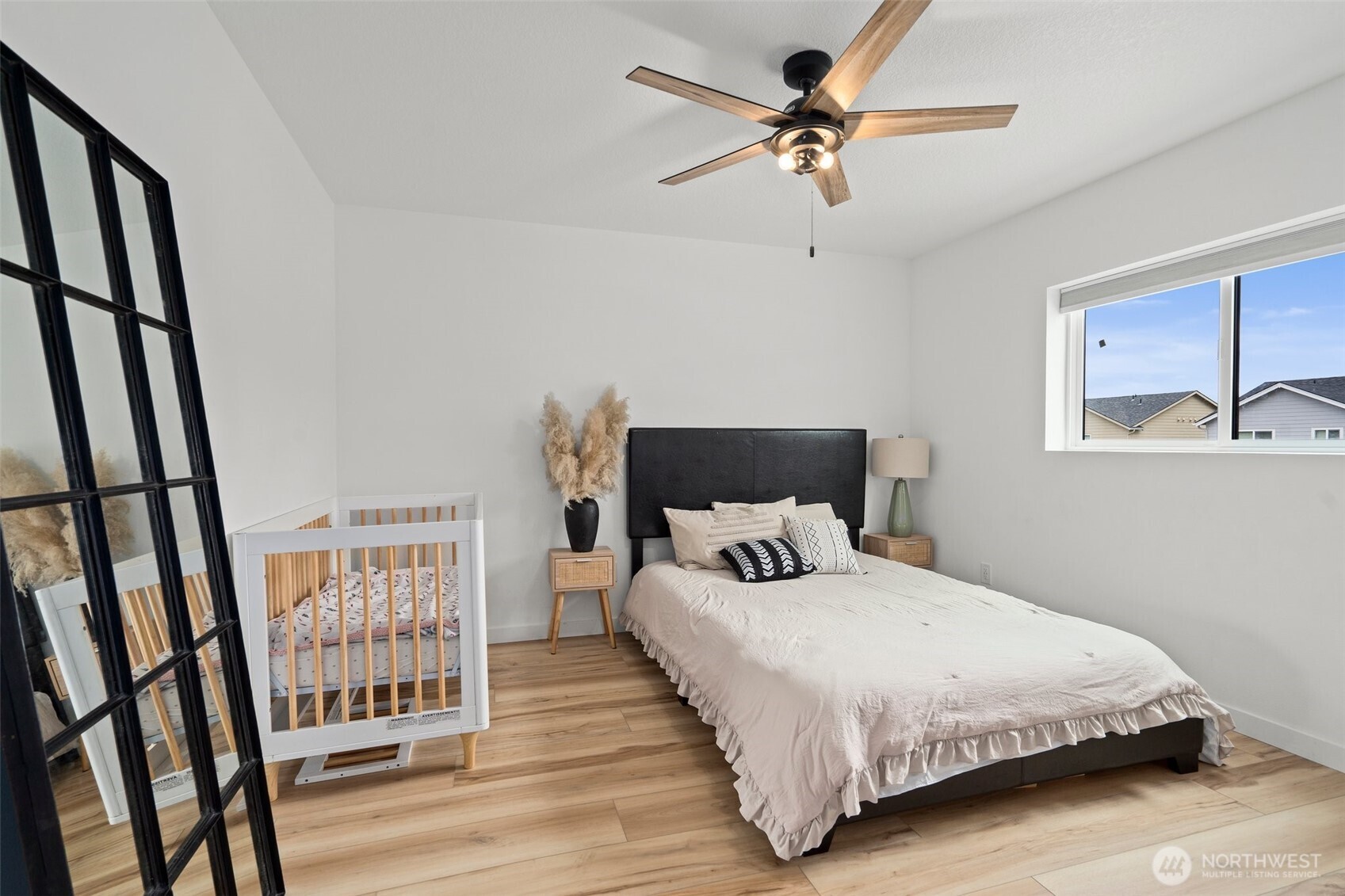 1013 Peach Road, Unit A & B Winlock, WA 98596 - Photo 16 of 30 a bedroom with a large bed and a chandelier