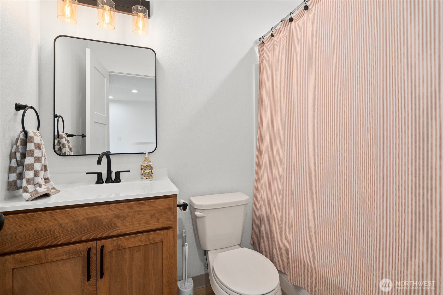 1013 Peach Road, Unit A & B Winlock, WA 98596 - Photo 21 of 30 a bathroom with a toilet a sink and mirror