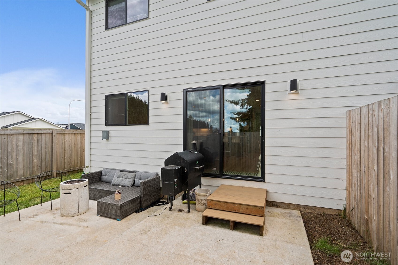 1013 Peach Road, Unit A & B Winlock, WA 98596 - Photo 24 of 30 a view of a patio with a table and chairs and wooden fence
