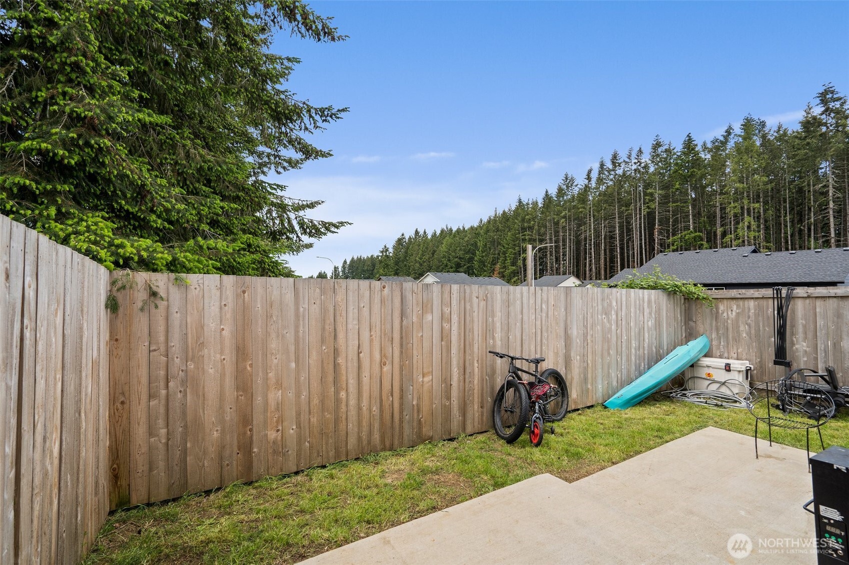 1013 Peach Road, Unit A & B Winlock, WA 98596 - Photo 25 of 30 a view of a backyard with a wooden fence