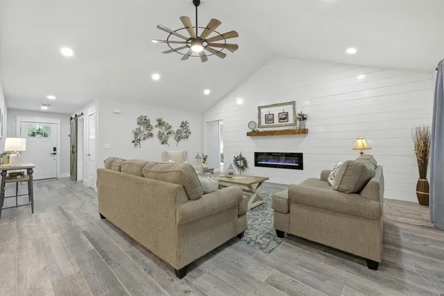 a view of a dining room with furniture wooden floor and chandelier