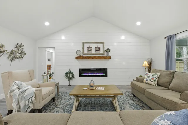 a view of a dining room with furniture wooden floor and a chandelier