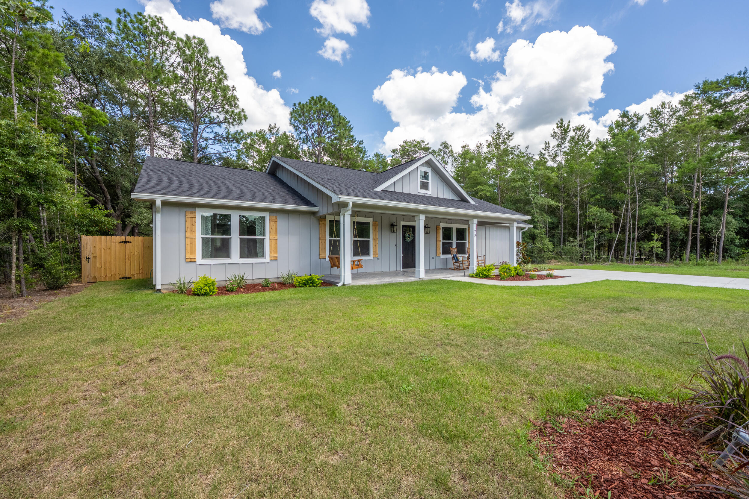 172 Frazier Road DeFuniak Springs, FL 32433 - Photo 2 of 79 a front view of a house with a garden